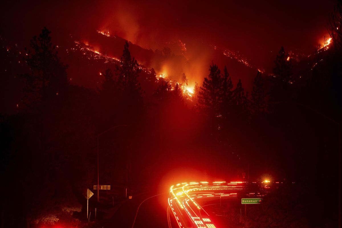 Fire trucks pass the Delta Fire burning in the Shasta-Trinity National Forest, Calif., on Wednesday, Sept. 5, 2018. (Noah Berger / Associated Press)