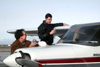 
Gary White, left, and his son Andrew, 19, go through a pre-flight check on the family airplane at Spokane Airways last week. An aspiring commercial pilot, Andrew will earn an associate's degree from Spokane Community College in June. The Whites are paying for Andrew's education through Washington's GET tuition-savings plan. 
 (Liz Kishimoto / The Spokesman-Review)