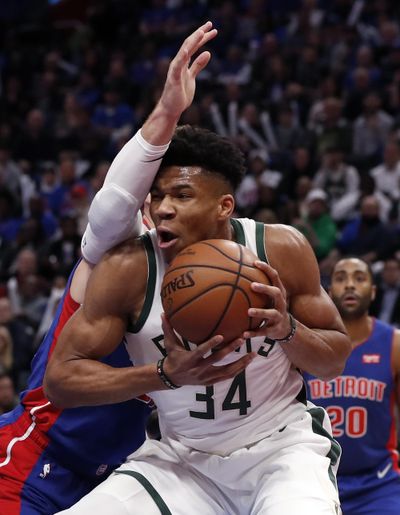 Milwaukee Bucks forward Giannis Antetokounmpo (34) is defended by Detroit Pistons forward Blake Griffin during the first half of Game 3 of a first-round NBA basketball playoff series, Saturday, April 20, 2019, in Detroit. (Carlos Osorio / Associated Press)