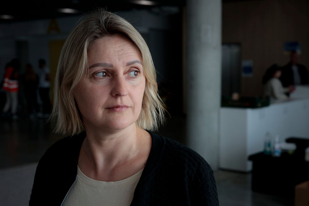 Diana Konstantynova, 45 years-old, accountant from Vinnytsia, Ukraine, poses after an interview with The Associated Press at a refugee center in Brasov, Romania, Wednesday, March 30, 2022. The number of Ukrainians who have fled the Russian war reached the dramatic new landmark of 4 million people, the United Nations announced Wednesday, as Moscow kept up its attacks — even in places where it had vowed to ease its military operations.  (Stephen McGrath)