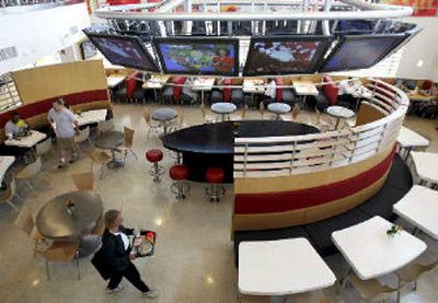 
Large plasma television screens are visible in the newly designed main dining room of McDonald's Corp's new flagship restaurant. 
 (Associated Press / The Spokesman-Review)