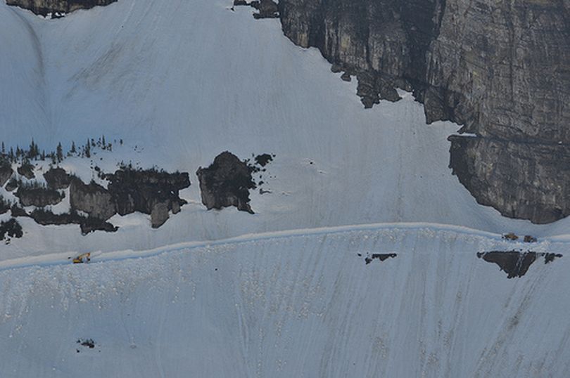 Snow removal equipment works along a dangerously steep slope on May 21, 2013, during the annual plowing to open the Going to the Sun Road in Glacier National Park. (National Park Service)