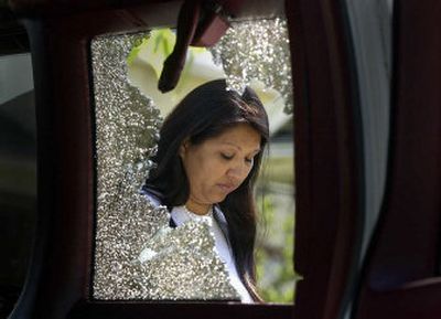 
Bonnie Joseph is framed in the shattered window of her van Tuesday, after racists allegedly attacked members of her family over the weekend. 
 (Christopher Anderson/ / The Spokesman-Review)