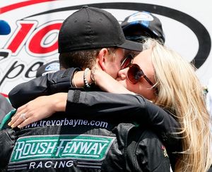 Trevor Bayne, driver of the #6 Ford EcoBoost Ford, celebrates winning the NASCAR Nationwide Series DuPont Pioneer 250 with his wife Ashton at Iowa Speedway on June 9, 2013 in Newton, Iowa. (Photo Credit: Kevin C. Cox/Getty Images) (Kevin Cox / Getty Images North America)