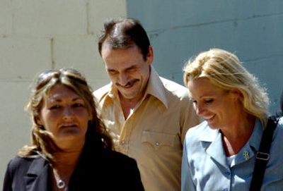 
Jonathan Ellington, center, walks to the Kootenai County Courthouse with his defense team Wednesday in Coeur d'Alene. 
 (Jesse Tinsley / The Spokesman-Review)