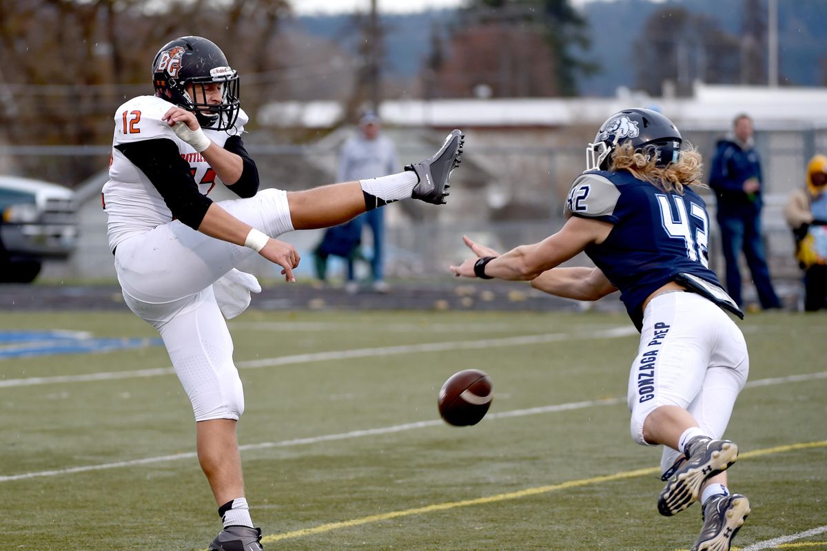 Gonzaga Prep’s Conor McKenna blocks a punt by Battle Ground’s Curtis Stradley, left, in the first quarter, leading to a touchdown for G-Prep Saturday, Nov. 14, 2015 at Gonzaga Prep. (Jesse Tinsley / The Spokesman-Review)