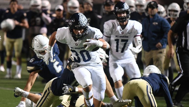 Mt. Spokane's Kannon Katzer (30) carries against Mead on Sept. 27, 2019, at Joe Albi Stadium. (COLIN MULVANY)