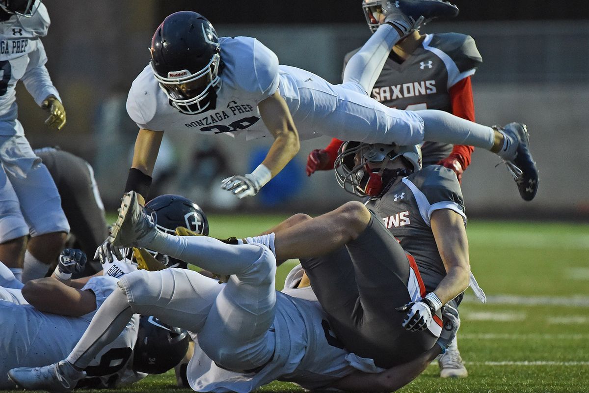 Gonzaga Prep defensive back Andrew Chan (30) leaps over Ferris Saxons wide receiver Anthony Aguirre (17) during a GSL football game on Fri. March 26, 2021 at Bullpup Stadium in Spokane WA.  (James Snook For The Spokesman-Review)