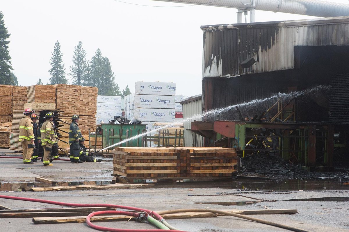 Firefighters mop up a fire that started at the Merritt Bros. Lumber Co. Inc. in Athol, Idaho Wednesday morning. The fire started in the plant