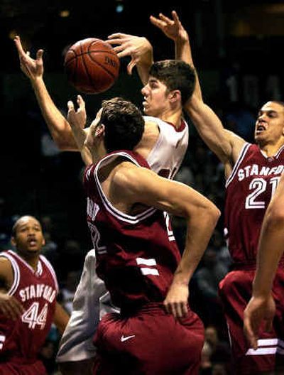 WSU player Robbie Cogwill goes into heavy Stanford traffic for a first-half offensive rebound Friday at the Spokane Arena.
(Brian Plonka / The Spokesman-Review)