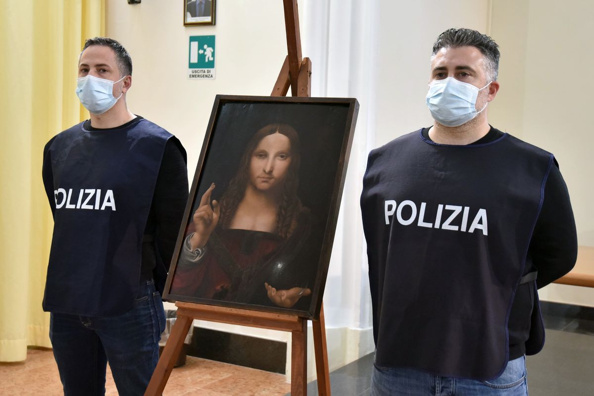 Italian police officers stand by a copy of the “Salvator Mundi” (Savior of the World) by Leonardo da Vinci, in Naples, Italy, Wednesday, Jan. 20, 2021. Italian police have recovered a copy of Leonardo da Vinci’s 16th century “Salvator Mundi” painting of Jesus Christ that was stolen from a Naples church without the priests even realizing it was gone. The discovery was made over the weekend when Naples police working on a bigger operation found the painting hidden in an apartment. Police chief Alfredo Fabbrocini said the owner offered a “less than credible” explanation that he had “casually” bought it at a small market.  (Polizia di Stato)