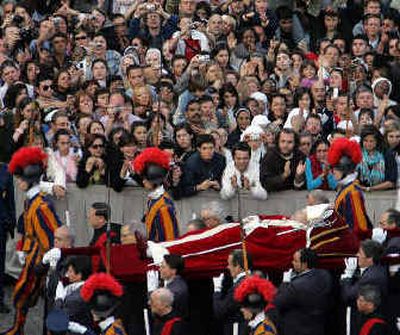 
Pallbearers carry the pope's body through a packed St. Peter's Square en route to the basilica at the Vatican on Monday.
 (Reuters / The Spokesman-Review)