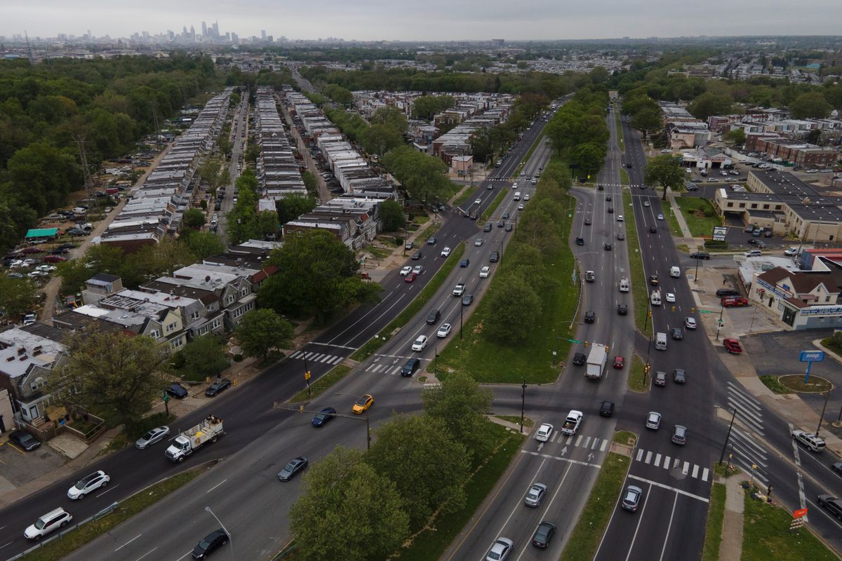 The Philadelphia skyline, top, is seen at a distance as vehicular traffic flows along Roosevelt Boulevard at the intersection with Whitaker Avenue, Thursday, May 12, 2022, in Philadelphia. Roosevelt Boulevard is an almost 14-mile maze of chaotic traffic patterns that passes through some of the city