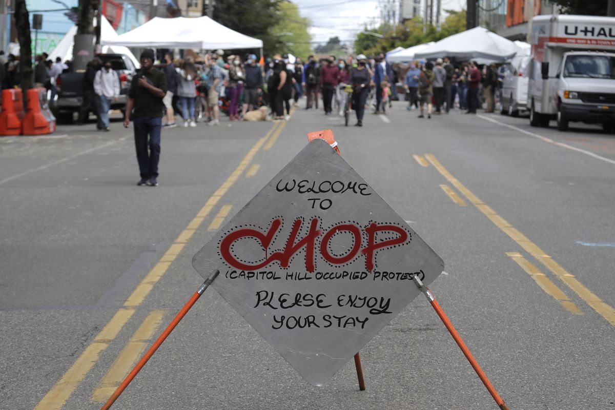 A sign reads “Welcome to CHOP” on Sunday inside what has been named the Capitol Hill Occupied Protest zone in Seattle. Protesters calling for police reform and numerous other demands have taken over several blocks east of downtown Seattle after officers withdrew from a police precinct in the area following violent confrontations. The name “CHOP” is a change from “CHAZ” (Capitol Hill Autonomous Zone) that was used to describe the area last week.  (Ted S. Warren)