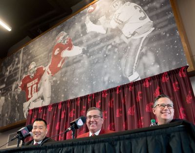 Patrick Chun, left, WSU’s new athletic director, smiles with university president Kirk Schulz, center, and Phil Weiler vice president of marketing and communication, right, during an introductory press conference for Chun on Tuesday, January 23, 2018, in the Rankich Club Room at Martin Stadium in Pullman, Wash.  (Tyler Tjomsland / The Spokesman-Review)