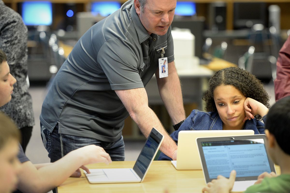 Teacher Jeff Van Horne helps seventh-grader Nova’lee Turner, 12, with a Wi-Fi-connected laptop she was using to take a practice test at Bowdish Middle School on Tuesday. (Jesse Tinsley)