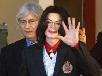
Pop singer Michael Jackson waves as he and his attorney, Thomas Mesereau Jr., leave the courtroom in California.
 (Associated Press / The Spokesman-Review)
