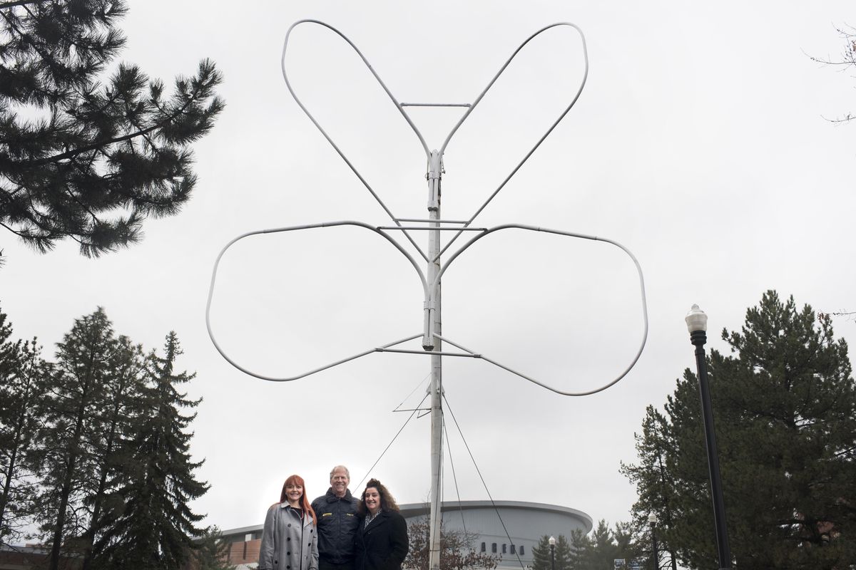 Jennifer Leinberger, left, founder of Save the Expo Butterflies, poses for a photo with Craig Lee, center, a structural engineer, and Kelli Johnson, a local Realtor,  in front of one of the Riverfront Park butterflies on Thursday in Spokane. (Tyler Tjomsland / The Spokesman-Review)
