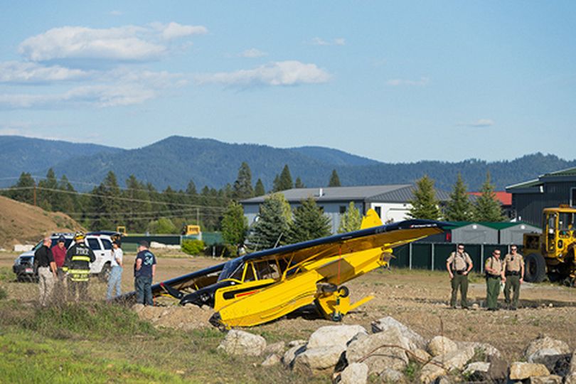Emergency crews work the scene where a float plane crashed near a field Wednesday at the north end of Reed Road in Hayden. No injuries were reported. (Shawn Press)