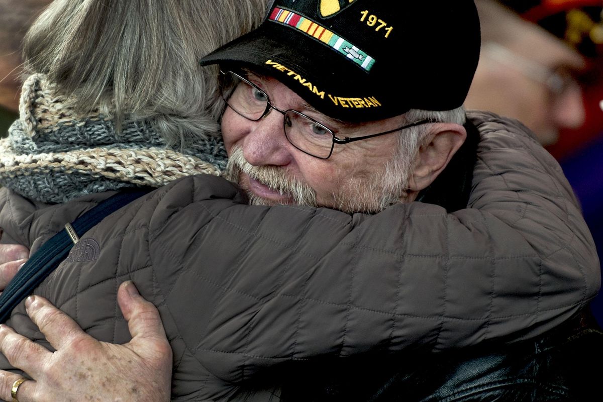 Vietnam and Desert Shield Army veteran Harold Watters gets a hug from Mary DeLateur during the Veterans Day Ceremony at Spokane Veterans Memorial Arena on Monday, Nov. 11, 2019. (Kathy Plonka / The Spokesman-Review)
