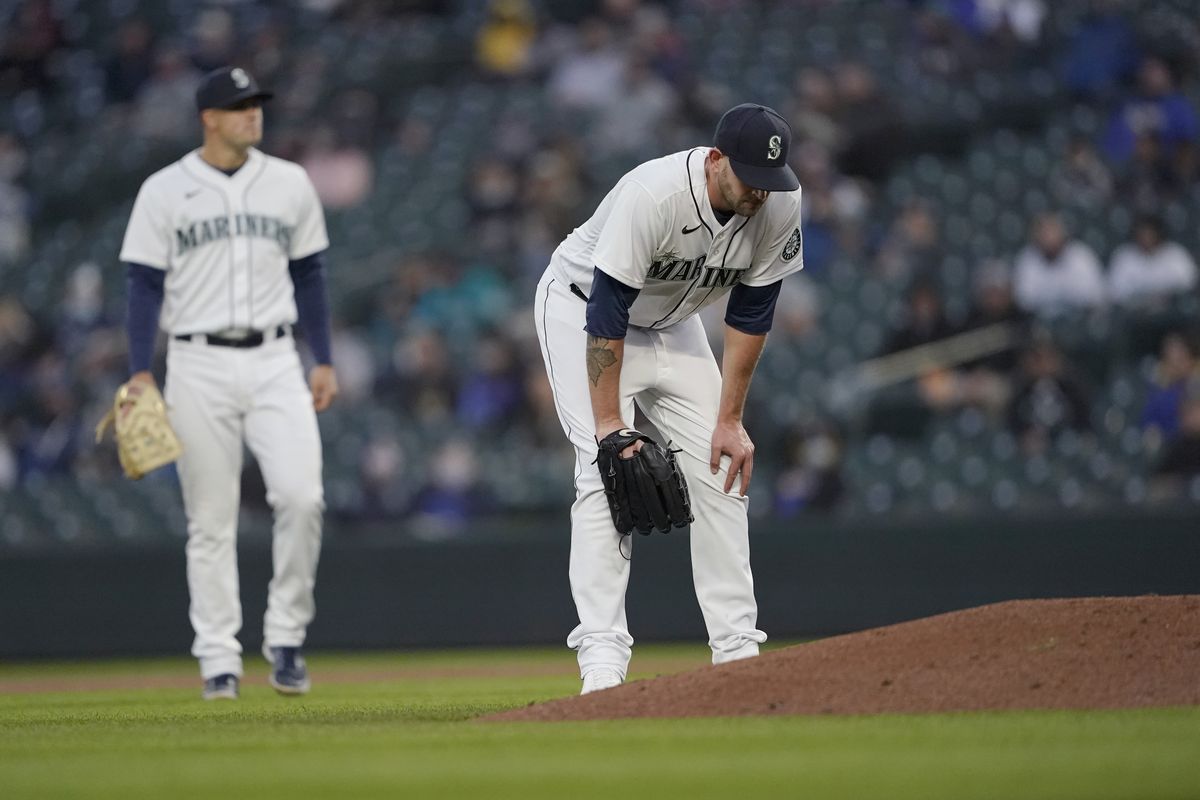 Seattle Mariners starting pitcher James Paxton, right, reacts near the mound after experiencing an injury during the second inning of a baseball game against the Chicago White Sox, Tuesday, April 6, 2021, in Seattle. Paxton left the game and the White Sox won 10-4.  (Associated Press)