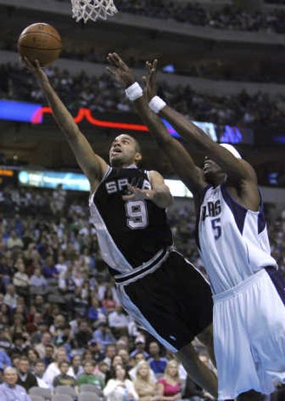 
Spurs guard Tony Parker slides past Josh Howard of the Mavericks during the first half Sunday.Associated Press
 (Associated Press / The Spokesman-Review)