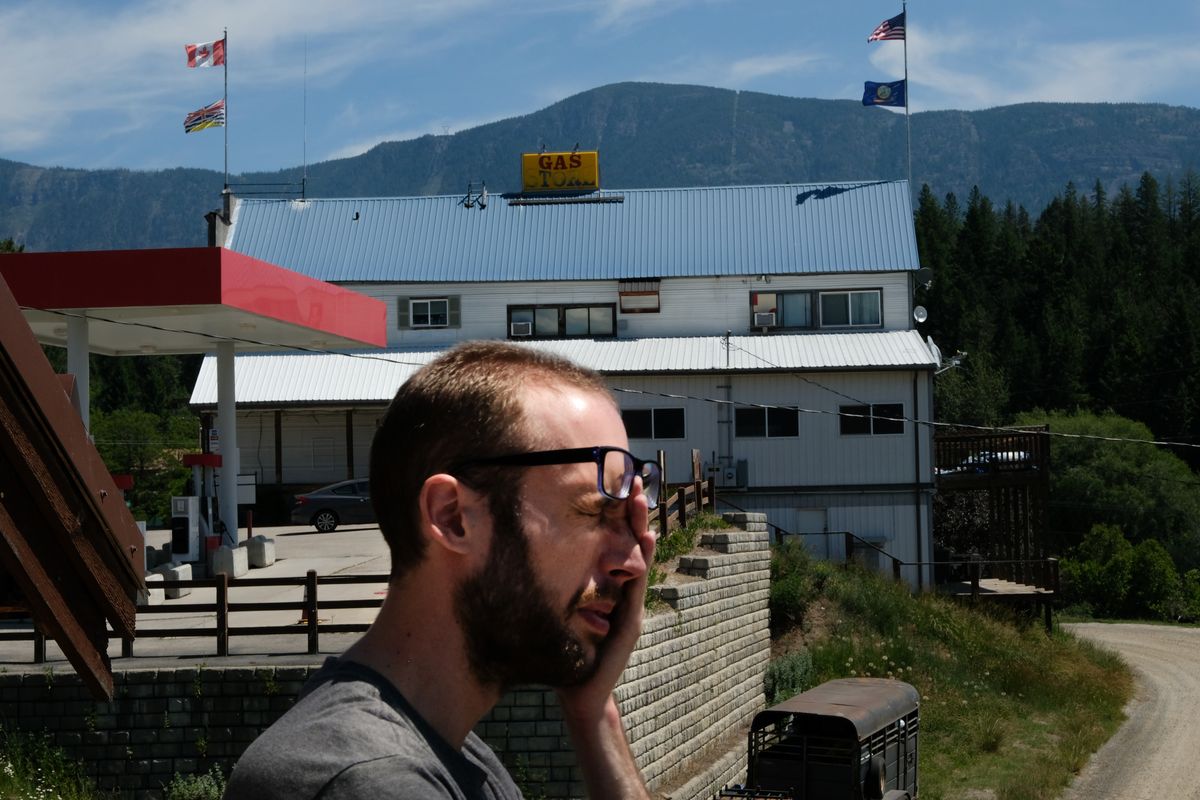 Landen Jacobson, 30, runs a hand over his face in the midday sun Tuesday outside his family’s store, Jakes Landing, near the Porthill Point of Entry near Porthill, Idaho. The Jacobsons bought several buildings on the Idaho–Canada border just before the pandemic hit.  (Tyler Tjomsland/The Spokesman-Review)