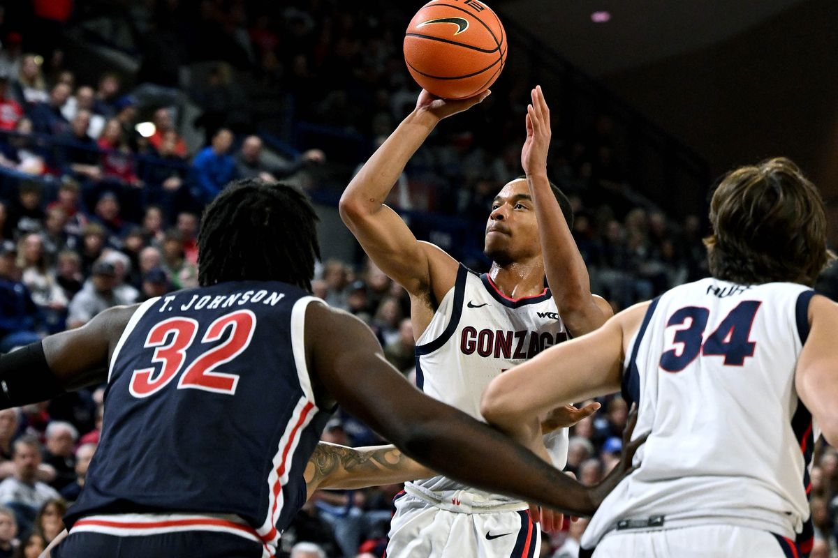 Gonzaga guard Nolan Hickman (11) shoots the ball as Jackson State center Treyon Johnson (32) defends during the first half of a NCAA college basketball game, Wednesday, Dec. 20, 2023, in the McCarthey Athletic Center.  (COLIN MULVANY)