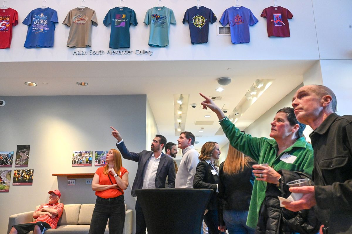 Bloomsday supporters Amy and Bob Lutz, right, along with Perennials and sponsors, view race finishers shirts at the Northwest Museum of Arts and Culture’s “14 Million Miles: 50 years of Bloomsday” exhibit unveiled Saturday in Spokane.  (DAN PELLE/FOR THESPOKESMN-REVIEW)