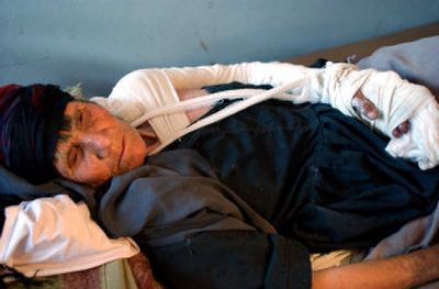 
An elderly Afghan woman wounded during military operations  lies on a bed at a hospital Wednesday in Afghanistan. Afghanistan can no longer accept civilian casualities, President Hamid Karzai said.
 (Associated Press / The Spokesman-Review)