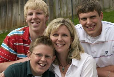 
Linda Szymanowski is surrounded at home by her boys Titus, 16, top left, Nate, 18, right, and Levi, 11. 
 (Dan Pelle / The Spokesman-Review)