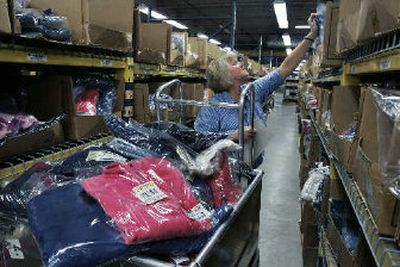 
An L.L. Bean worker reaches for items as she fills orders from the multitude of shelves at L.L. Bean's distribution center in Freeport, Maine. On a recent day approximately 110,000 items were shipped. 
 (Associated Press / The Spokesman-Review)