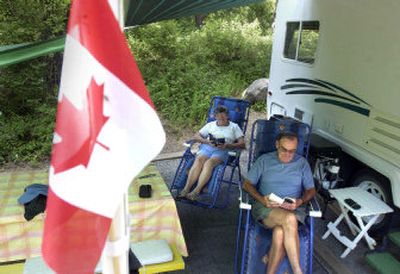 
Dave and Audrey Dawson of Calgary, Alberta, spend Thursday afternoon with some paperback novels at a campsite at Farragut State Park. The park is full, but the Dawsons got reservations in advance. 
 (Jesse Tinsley / The Spokesman-Review)