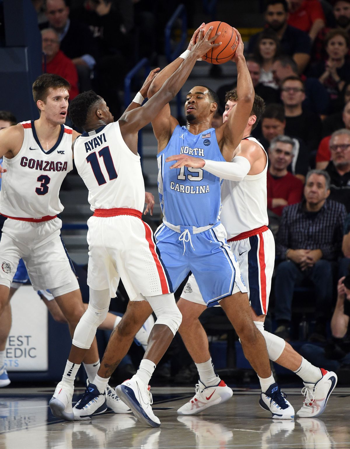 Gonzaga’s Joel Ayayi and Corey Kispert, right, swarm North Carolina’s Garrison Brooks during a Dec. 18, 2019, game the Zags won 94-81 at McCarthey Athletic Center.  (Colin Mulvany/The Spokesman-Review)