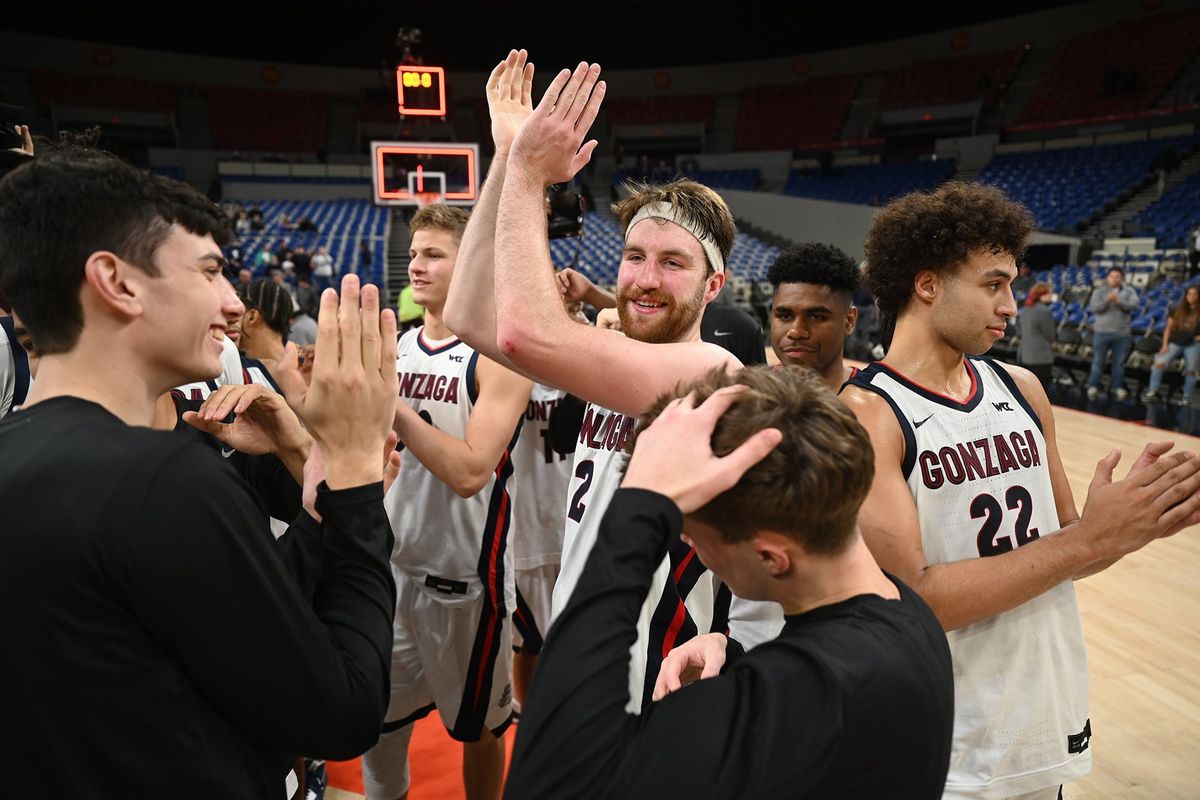 Gonzaga forward Drew Timme, center, and his teammates celebrate after a postgame huddle after Gonzaga beat Xavier for third place in the Phil Knight Legacy tournament in the Veterans Memorial Coliseum in Portland, Oregon Sunday, Nov. 27, 2022.  (Jesse Tinsley/The Spokesman-Review)