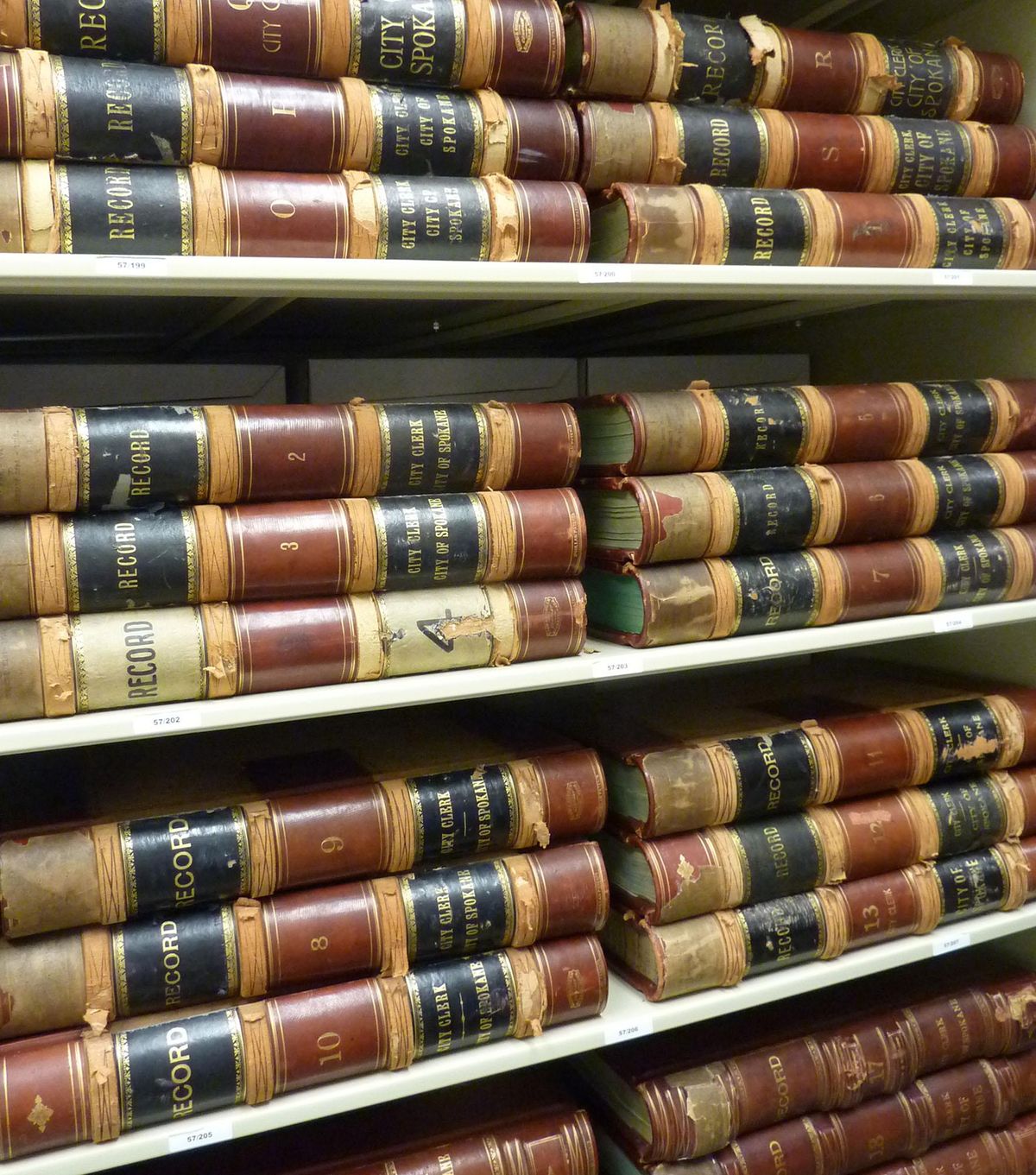 This shows a stack of the City of Spokane journal books as they are stored on shelves at the Washington State Archives Eastern Branch in Cheney. The oldest dates back to 1887. (Stefanie Pettit / The Spokesman-Review)