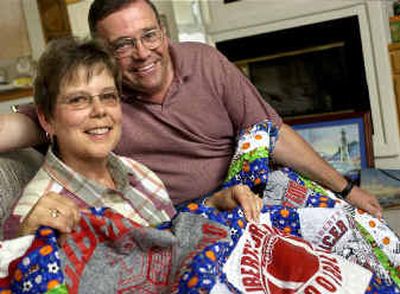 
Sammie and Rod Fletcher are retiring with a combined total of 64 years of teaching in the Liberty School District in Spangle. They sit covered by a quilt Sammie made for Rod's retirement. The quilt is made of T-shirts and sweatshirts Rod wore while coaching junior high and high school sports. 
 (Holly Pickett / The Spokesman-Review)