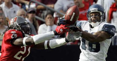 
Seahawks wide receiver D. J. Hackett battles for the ball. 
 (Associated Press / The Spokesman-Review)