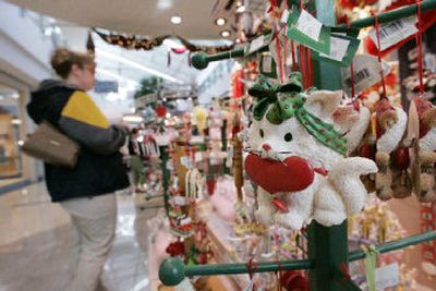 
An unidentified shopper browses at the Santa's Pen cart at Stonebriar Mall in Frisco, Texas. They sit uniformly lined in the center of mall, attracting curious shoppers while suddenly turning the retail center's walkway into a money-making promenade. 
 (Associated Press / The Spokesman-Review)