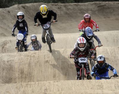 Tanner Gillingham (No. 919) leads a group of 11 novice racers at the Dwight Merkel Sports Complex’s BMX track on May 22. Eric Sawyer, president and CEO of the Spokane Regional Sports Commission, calls the track “one of the best BMX facilities on the West Coast.” (J. Bart Rayniak)