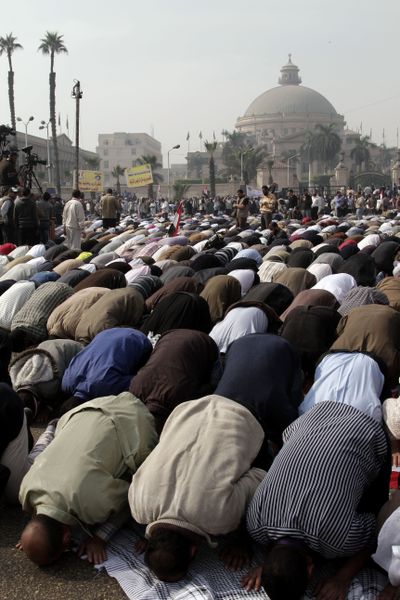 Supporters of Egyptian President Mohammed Morsi pray during a rally in front of Cairo University on Saturday. (Associated Press)