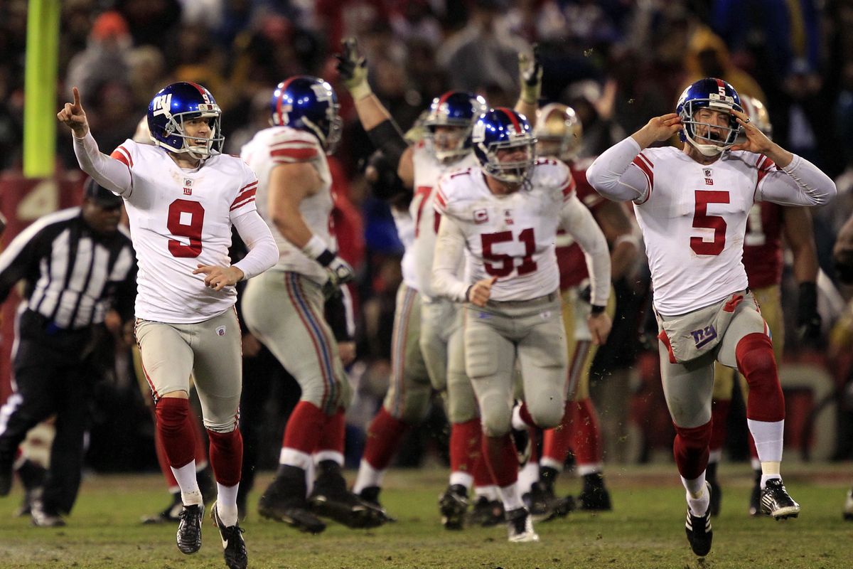 Giants kicker Lawrence Tynes (9) and punter/holder Steve Weatherford (5) celebrate after Tynes kicked the game-winning field goal Sunday. (Associated Press)