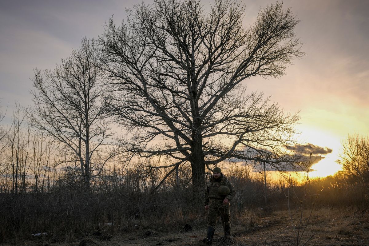 A Ukrainian serviceman walks to a frontline position outside Popasna, in the Luhansk region, eastern Ukraine, Sunday, Feb. 20, 2022. Russia extended military drills near Ukraine