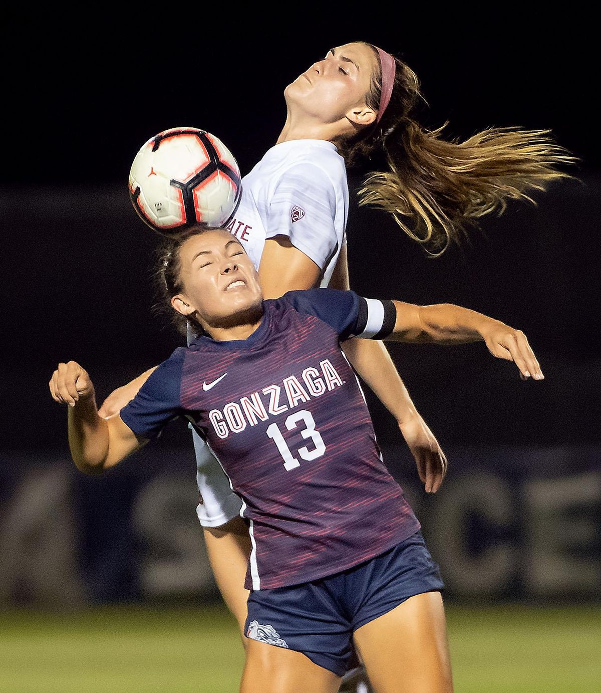 Gonzaga forward Madeline Gotta (13) heads the ball as WSU midfielder Averie Collins defends, Thurs., Sept. 5, 2019, at Gonzaga University. (Colin Mulvany / The Spokesman-Review)