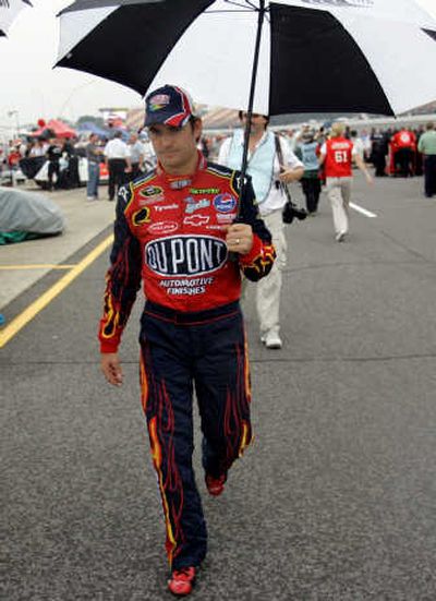 
Jeff Gordon walks back to the garage after rain canceled qualifying for Sunday's LifeLock 400. Associated Press
 (Associated Press / The Spokesman-Review)