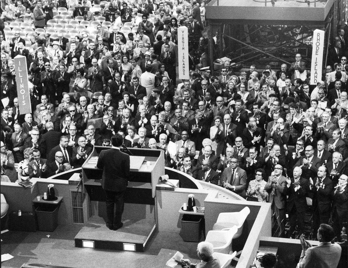 Delegates applaud the keynote speech by Sen. Daniel Inouye of Hawaii during the Democratic National Convention In Chicago on Aug. 28, 1968. Chicago Mayor Richard M. Daley is visible directly under the Illinois sign.   (Chicago Tribune/TNS)