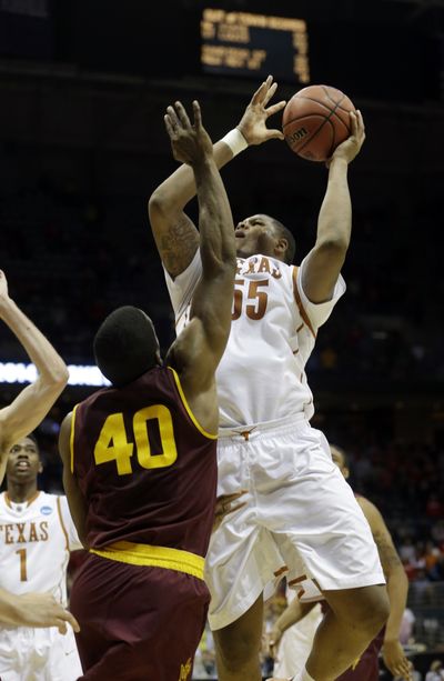 Texas center Cameron Ridley (55) scores off a missed 3-pointer at the buzzer on Thursday. (Associated Press)