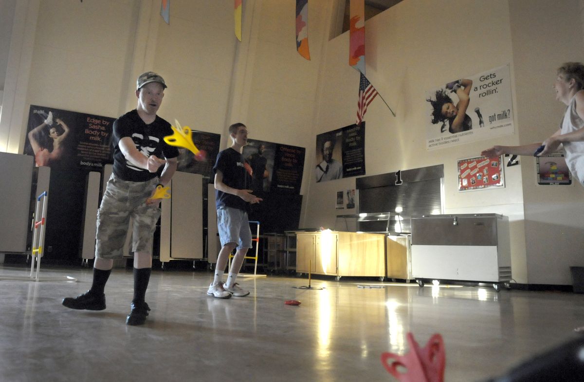 Herb Miller tosses magnetic darts during a Cheney WAVE meeting May 28. (CHRISTOPHER ANDERSON / The Spokesman-Review)