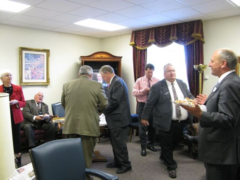 House members gather for pizza in a room behind their chamber, as their session stretches into the evening on Wednesday. (Betsy Russell / The Spokesman-Review)