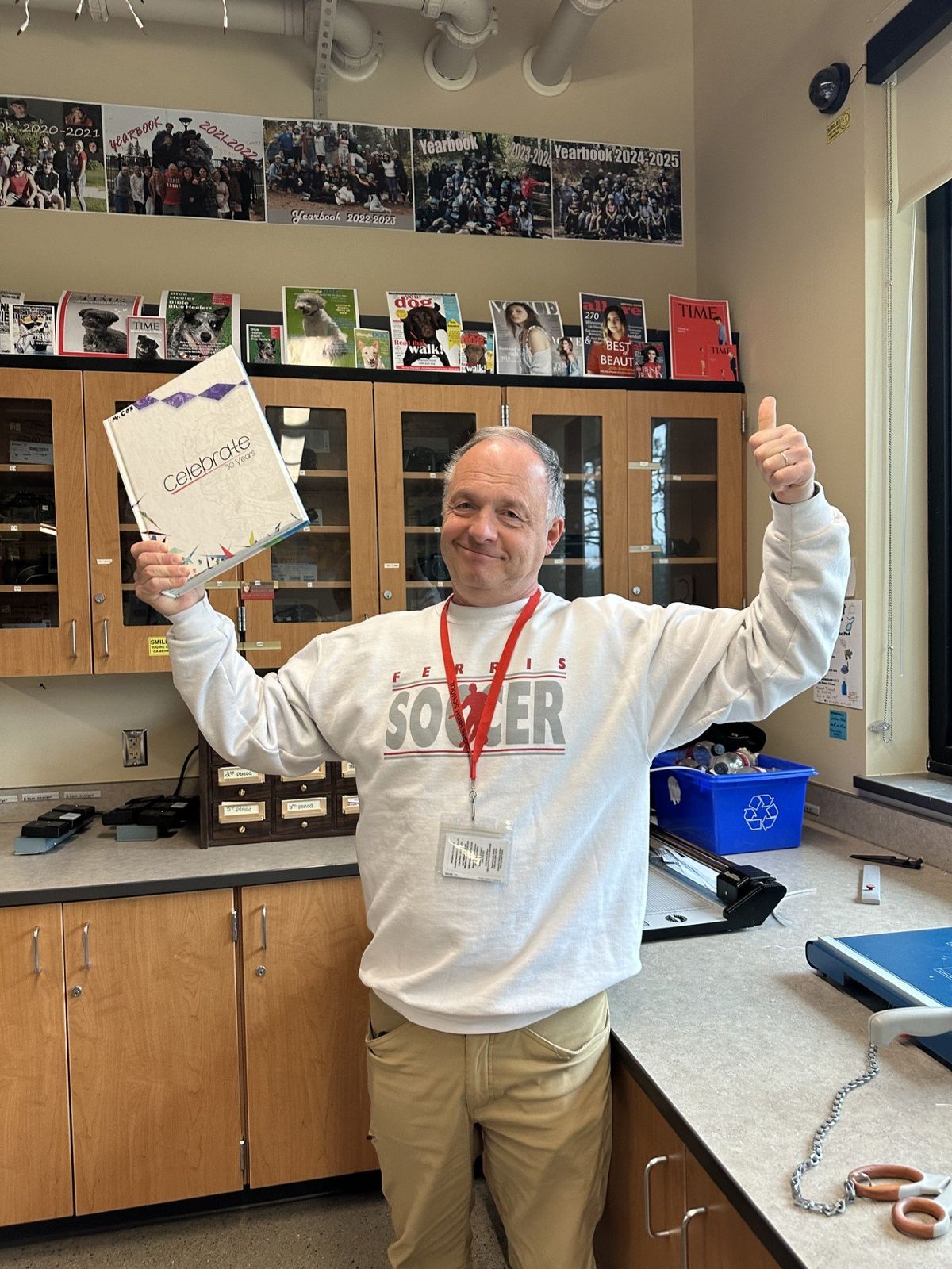Ferris High School teacher and yearbook adviser Tim Cox displays a copy of his favorite Ferris Exeter yearbook, the 50-year anniversary edition. Cox will be retiring at the end of this school year. (Cynthia Reugh/For The Spokesman-Review)